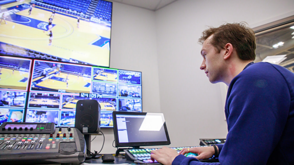 Monmouth student using a computer inside Parton Broadcast Center