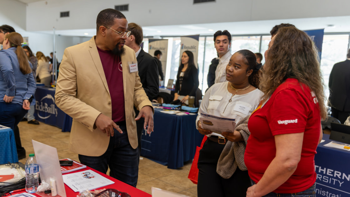 Business students talking to potential employer at Career Fair