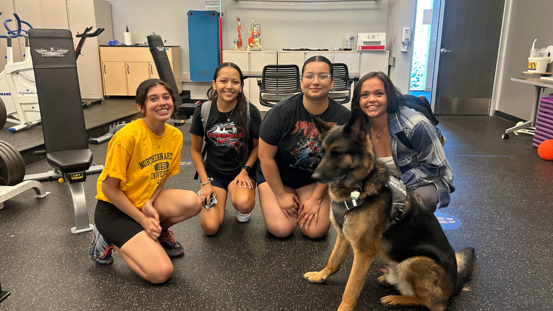 Fitness and Welness students posing with dog