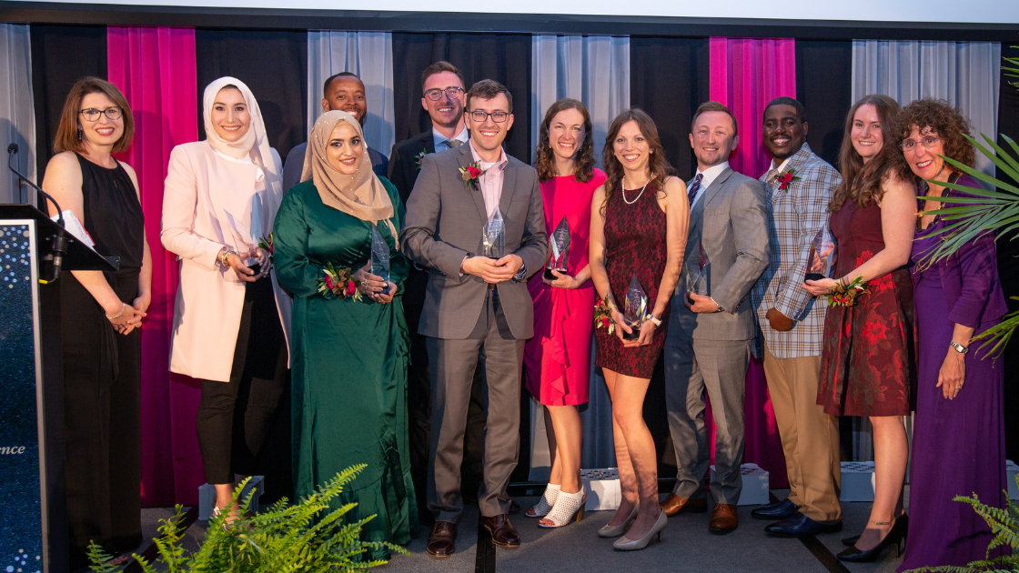 Image of OU alums standing on stage at the OU Alumni Night of Excellence