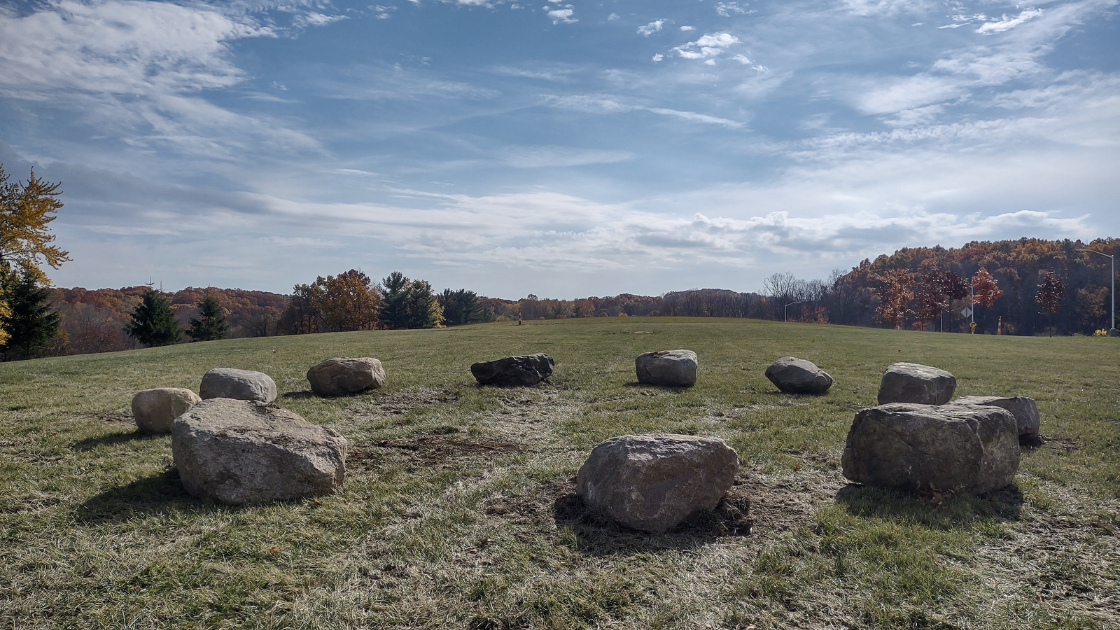 Stones sitting in the grass on Oakland University's campus.