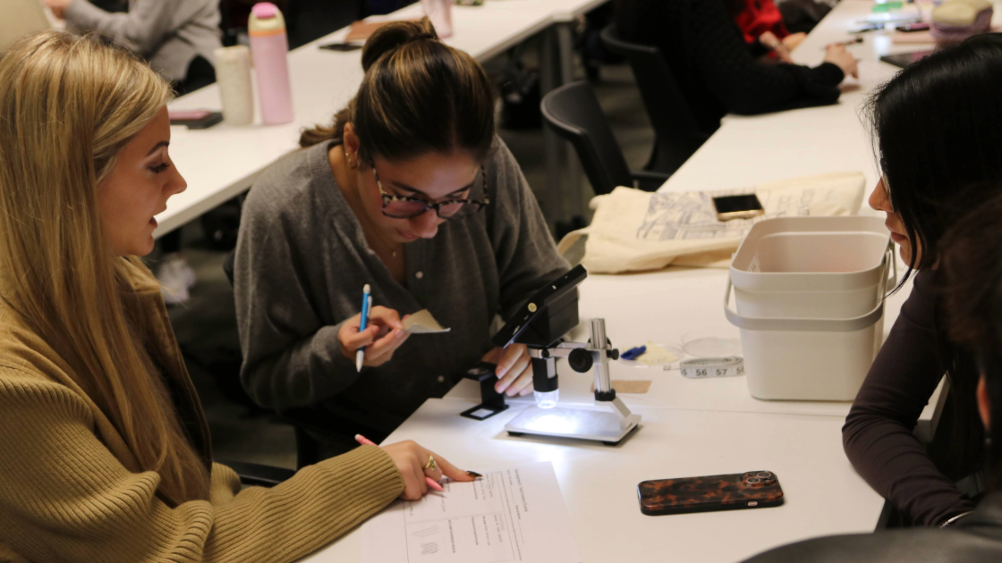 3 Female Students Working with Microscope