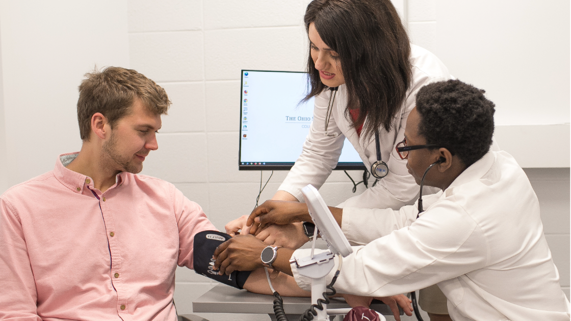 2 Pharmacists with a Patient