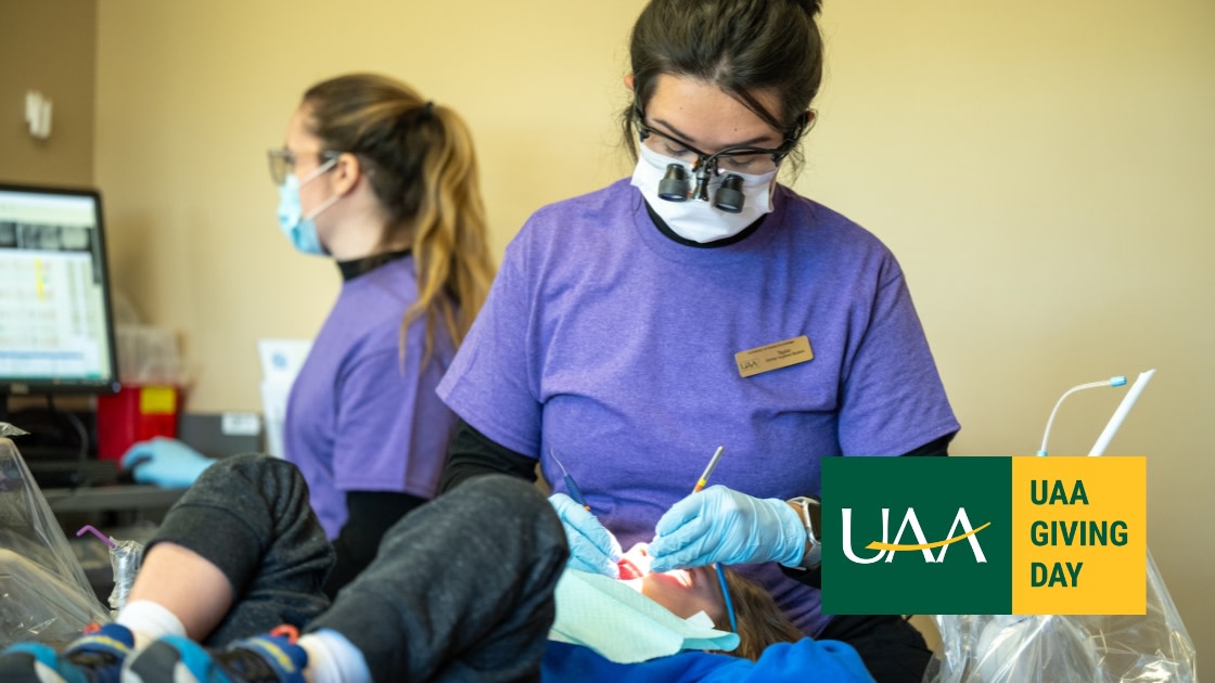 Dental hygiene student gives a young patient a checkup during UAA Cares for Kids Day