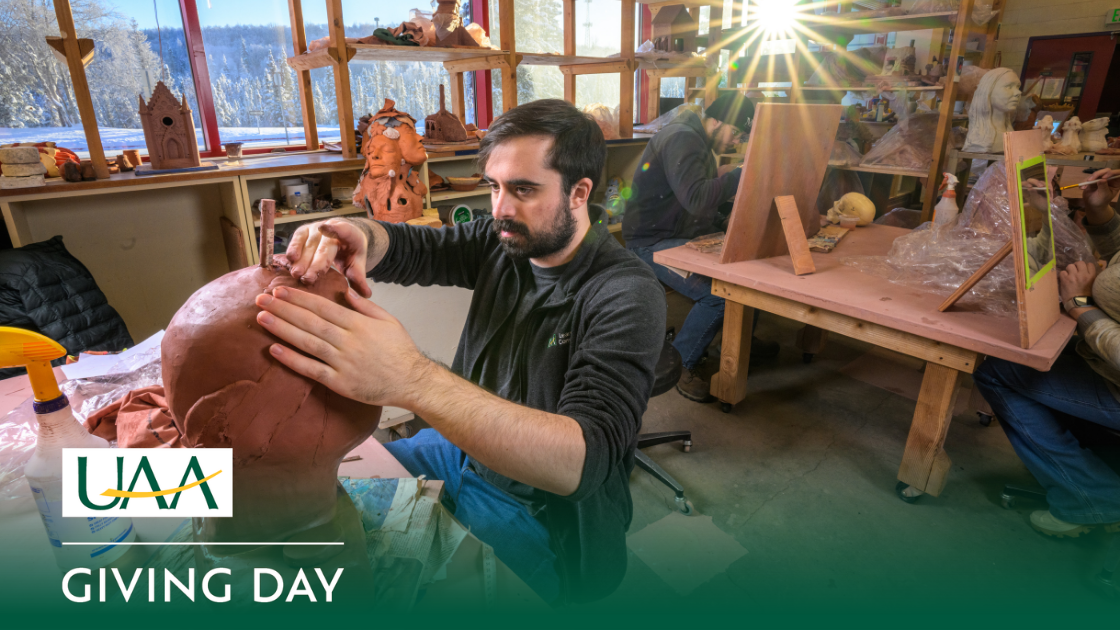 UAA student works on a self portrait in clay in Beginning Handbuilt Ceramics