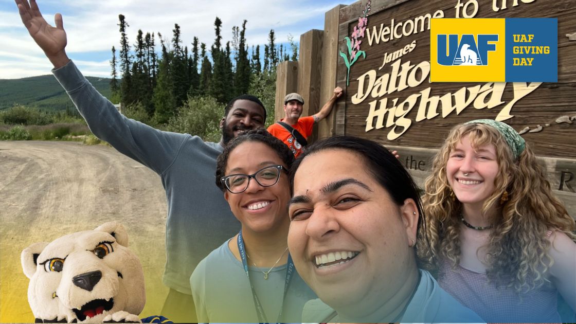 UAF students and staff in front of the Dalton Highway sigh