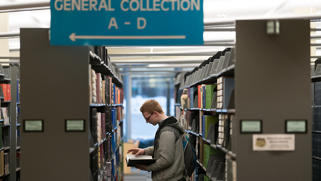 Student picking out a book