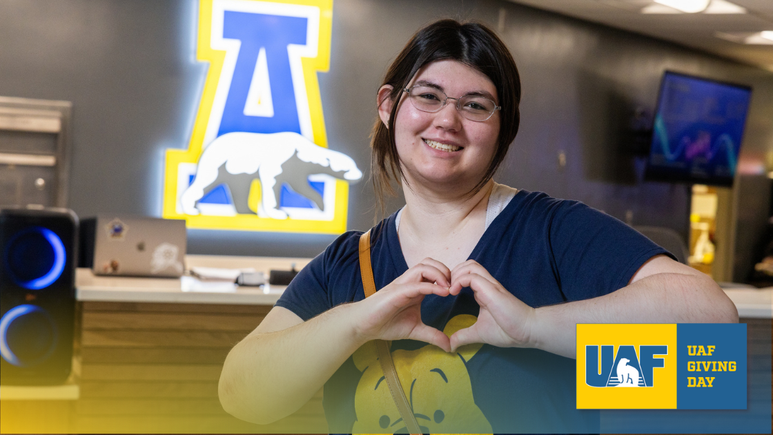 UAF student making a heart sign with hands in class