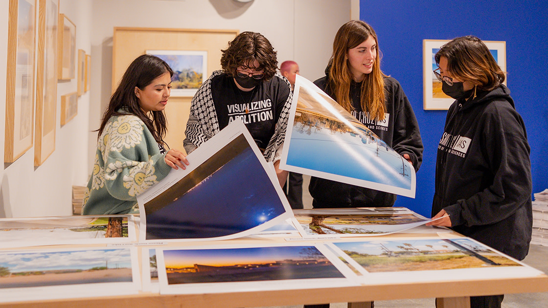 UCSC students looking through Ashley Hunt's "Degrees of Visibility."