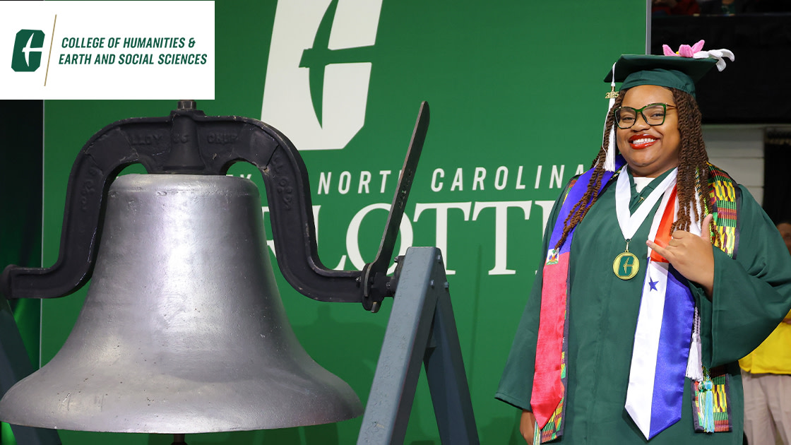 CHESS graduate with the bell flashing a pickaxe hand sign