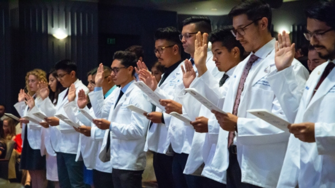 UCI medical students in white lab coats taking the Hippocratic oath
