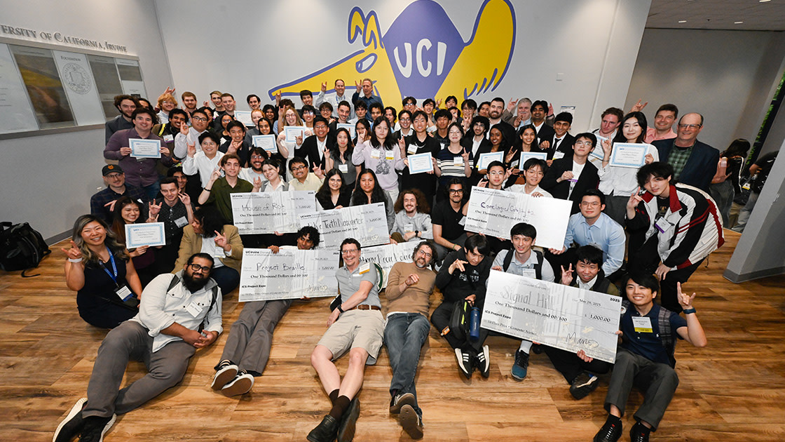 A large group of students and staff celebrating at the 5th annual UC Irvine ICS Project Expo
