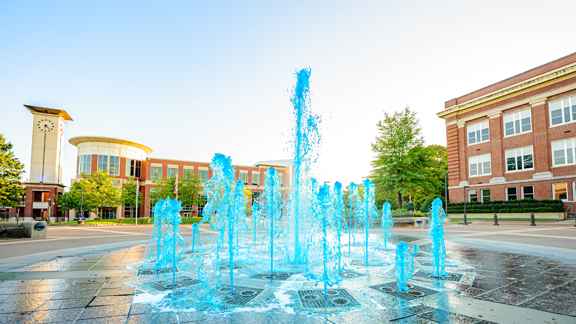 University of Memphis fountain spraying blue water