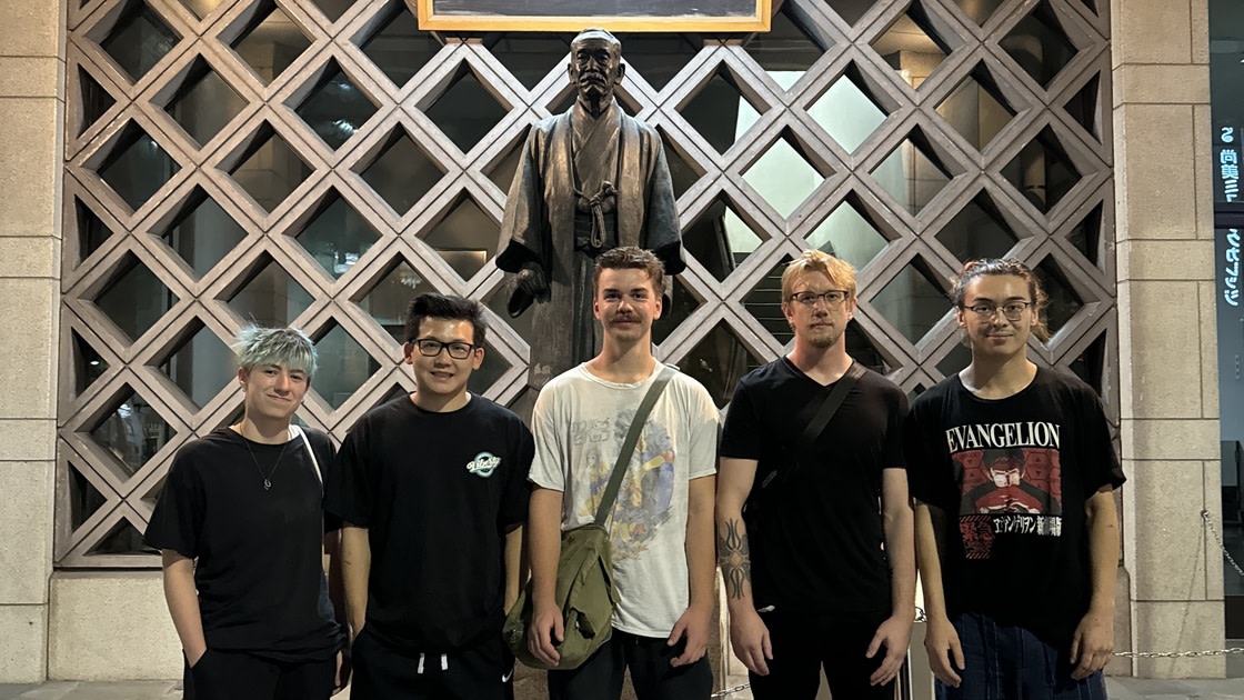 Club members in front of the statue of Jigoro Kano, founder of judo and the Kodokan