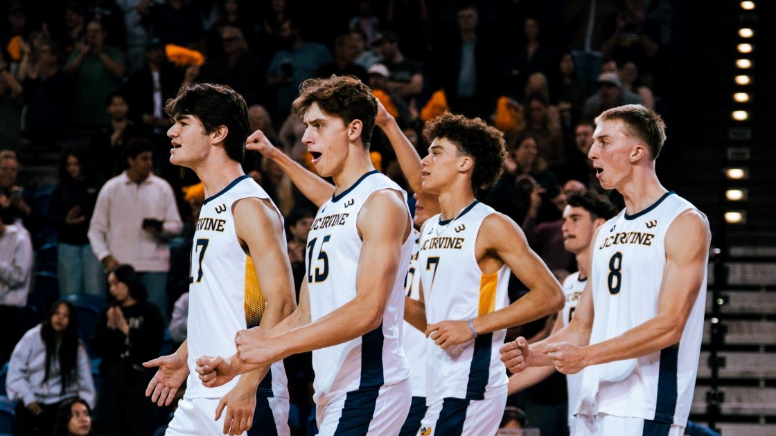 The UCI men’s volleyball team getting excited and yelling as they walk out onto the court