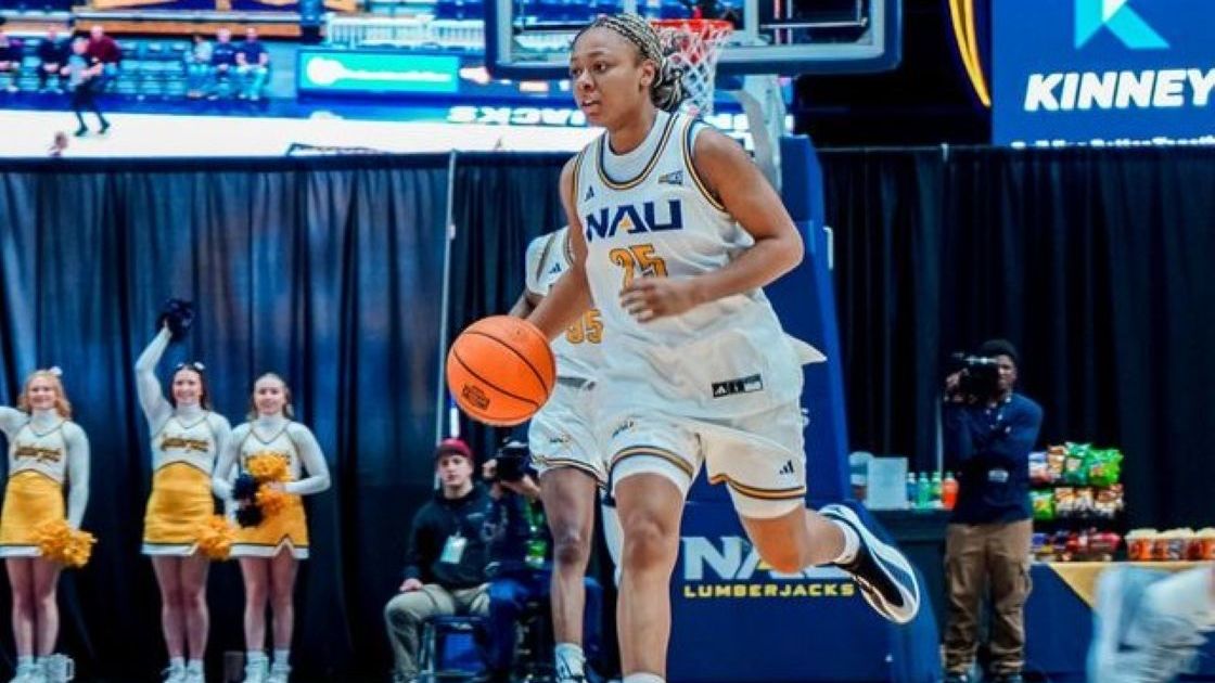 Women’s basketball bench cgeering during a game on the court sideline.