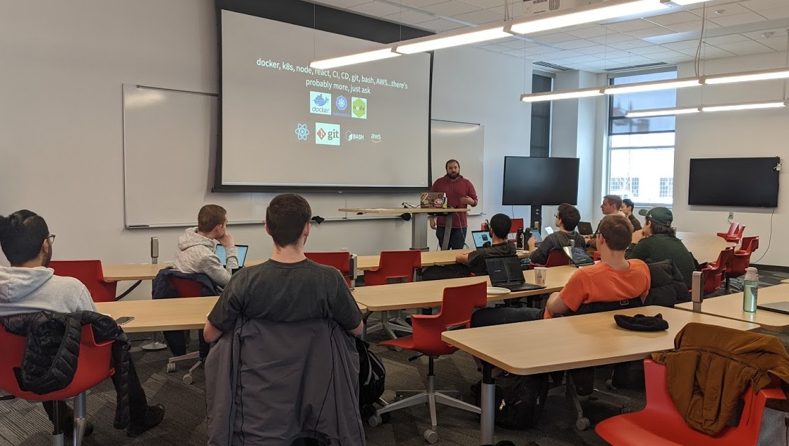 SSE Students listen to a Dev-Ops Workshop Presentation.