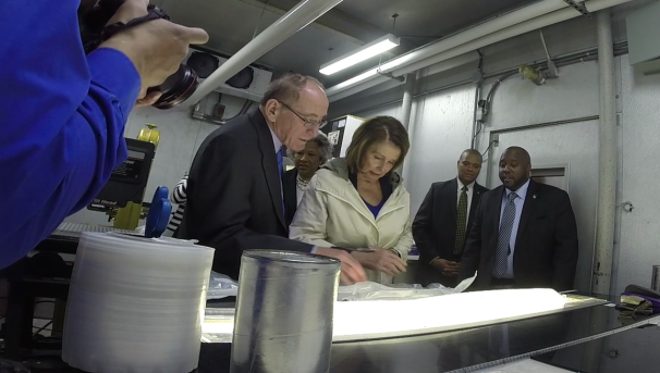 Politicians working and looking at a sample from inside the Buckeye Ice camp