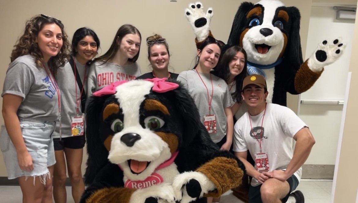 Group of Buck-I-SERV participants posing with two dog mascots