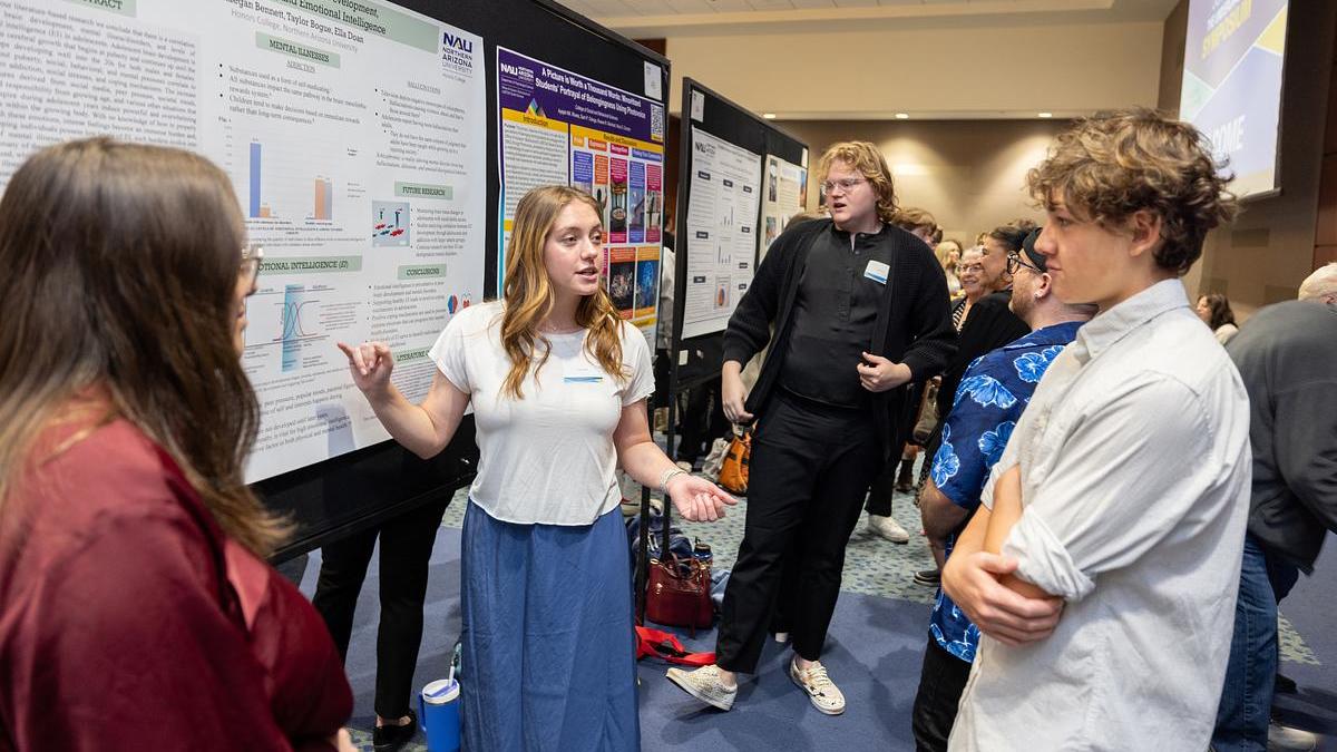 Students presenting and chatting at the Undergraduate Research Symposium.
