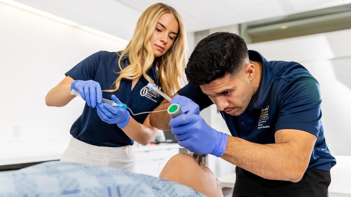 NAU students practicing a clinical procedure on a simulator