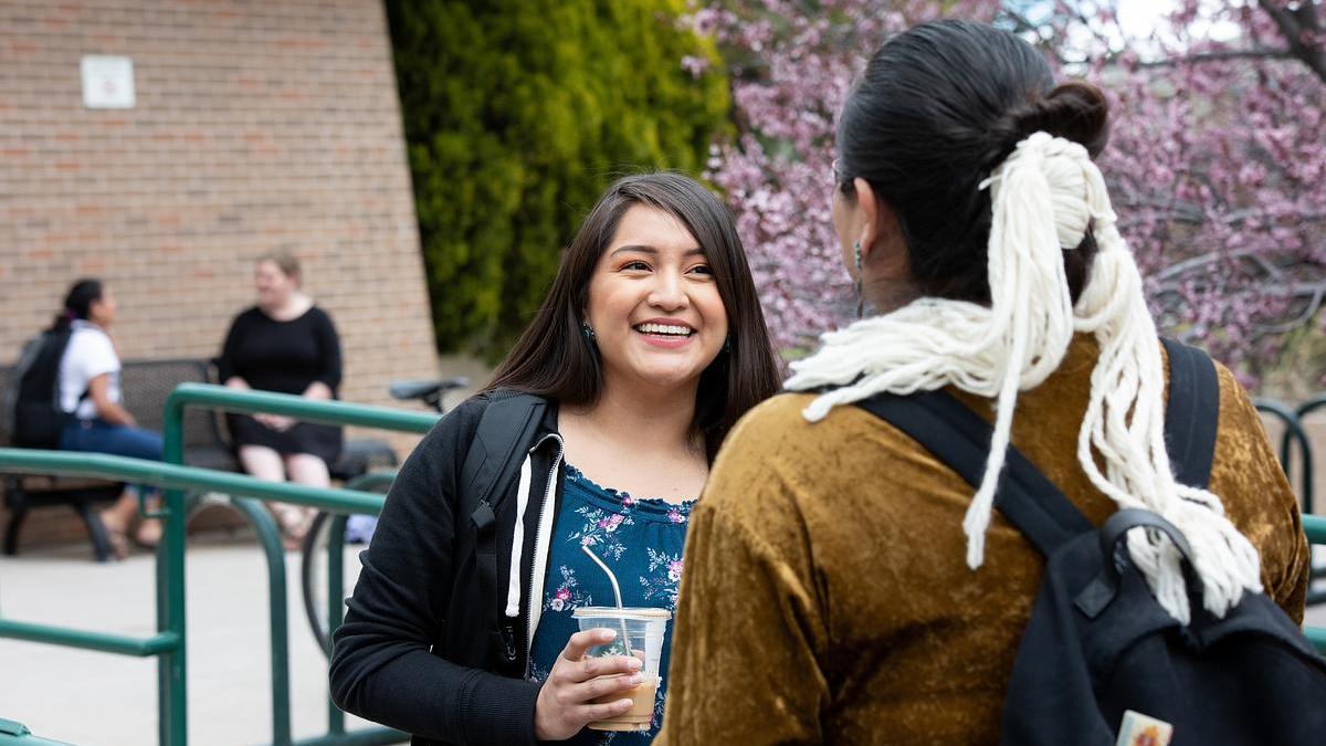 Students having conversation on-campus.