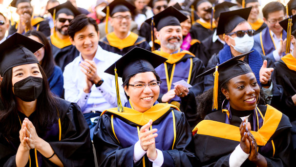 I School graduates clapping in the audience at graduation