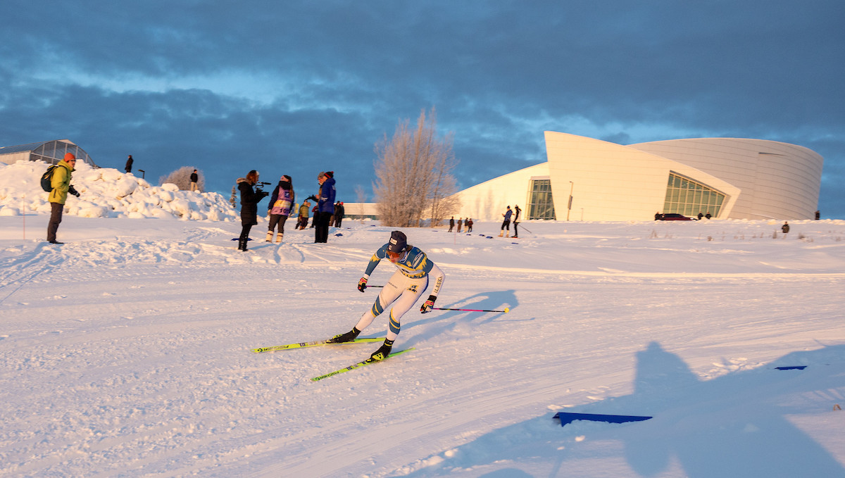 Nanook skier racing in front of the UAF Museum of the North.
