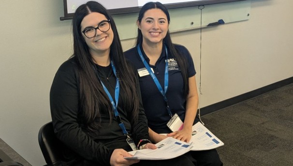 Doctoral OT students Janelle and Ariana sitting together before a conference presentation.