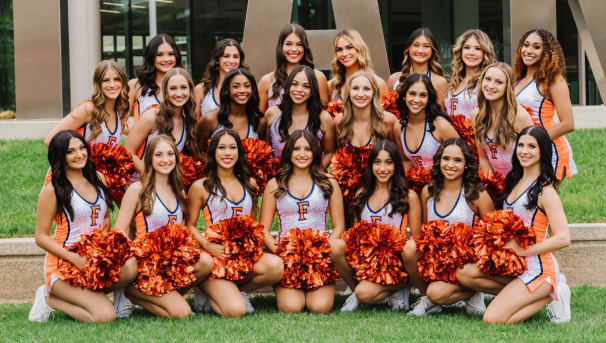 Dance team members holding poms