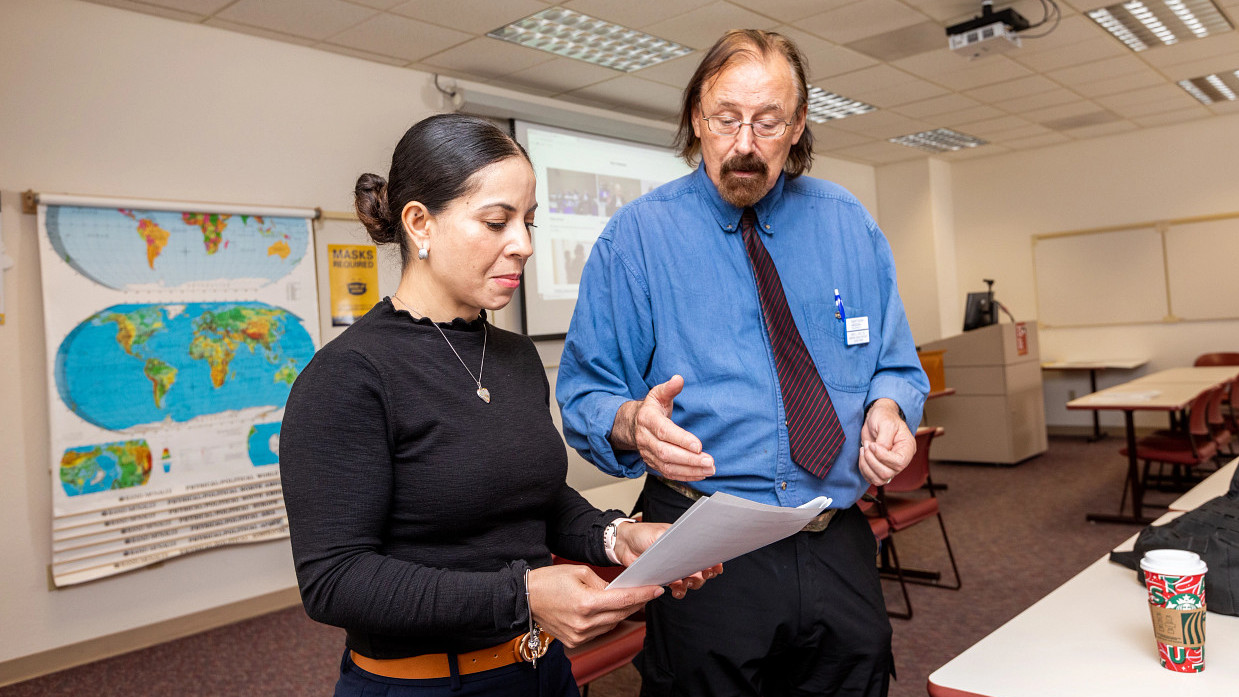 Faculty member reviewing work with student