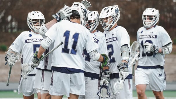 Monmouth men's lacrosse student-athletes celebrate a goal.