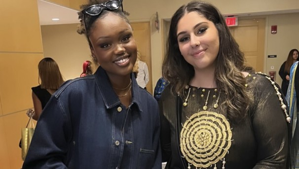 Two individuals smiling for a photo. They are inside the Ohio Union