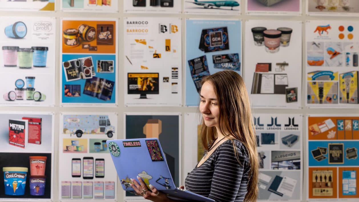 A NAU visual communication student reviewing design workge