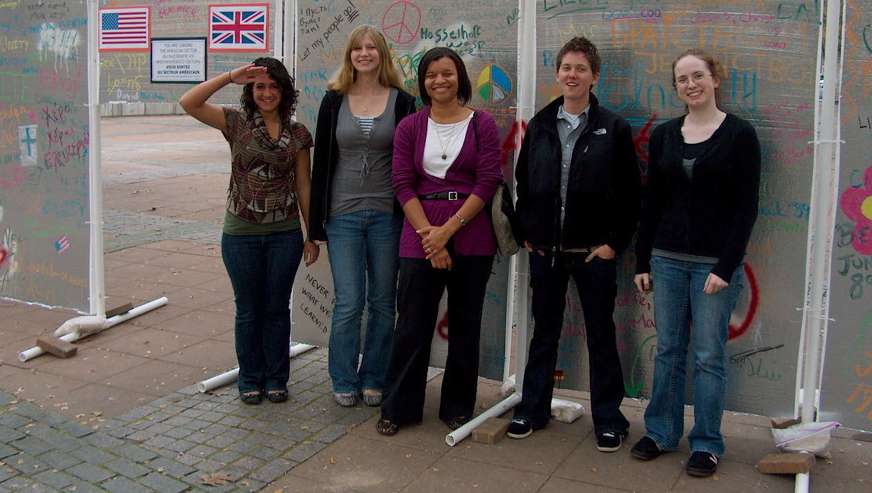Groups of students standing together outside.