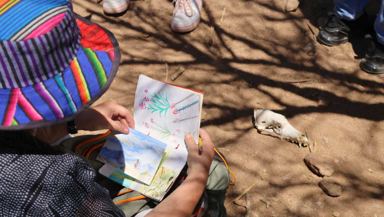 Educator, Aliya, Showing Students How to Use Their Nature Journals After Spotting a Coyote Skull
