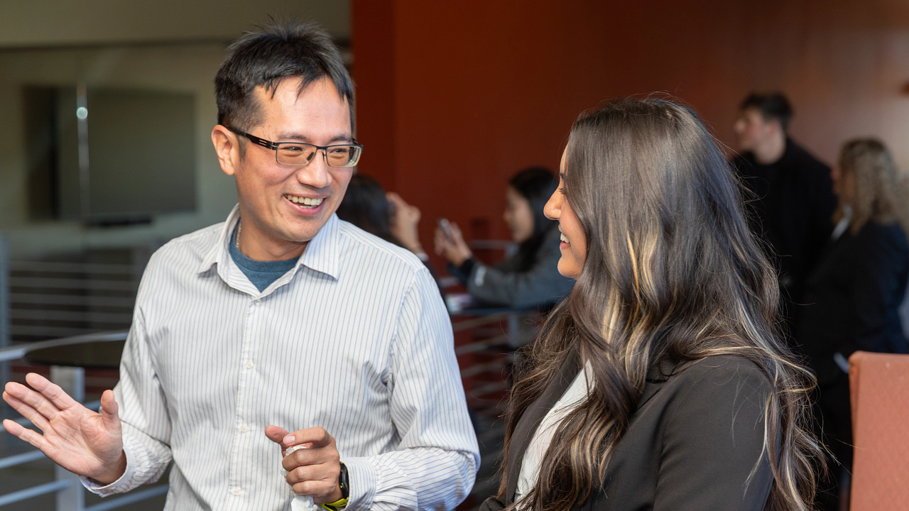 Professional man and woman speaking to each other