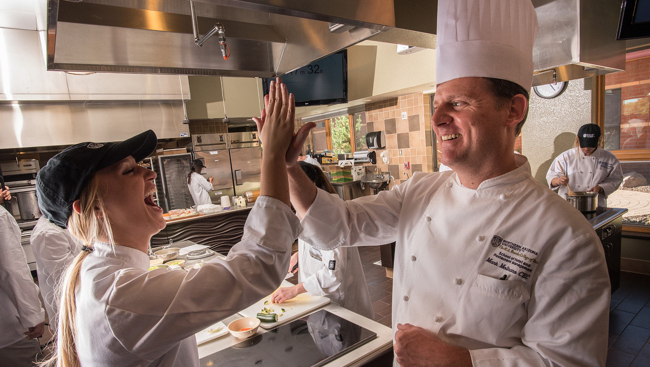 Chef working with students in the HRM kitchen