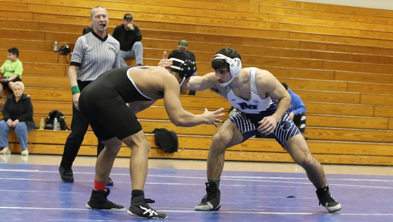 Monmouth wrestler preparing to wrestle a student from another institution