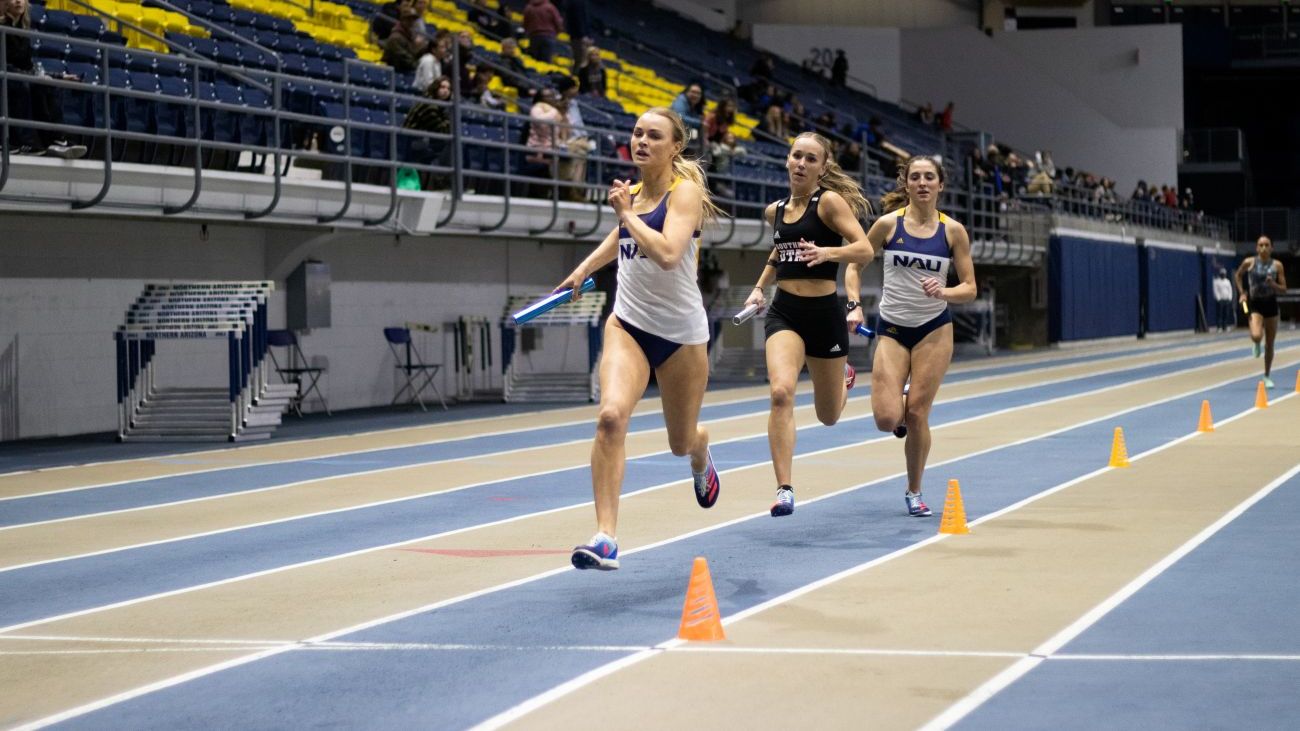NAU running back carries the ball through opposing defense during a home game.