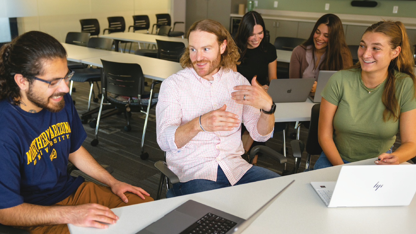 Psychology students in group discussion with their professor