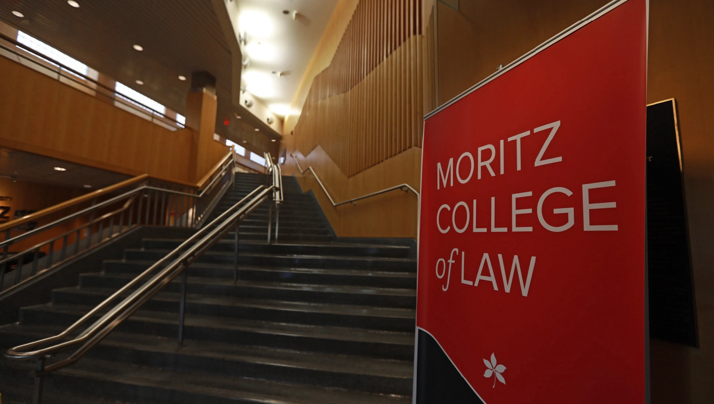 A staircase with a Moritz College of Law sign at the bottom
