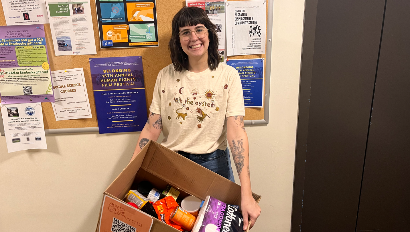 Member holding box of food items