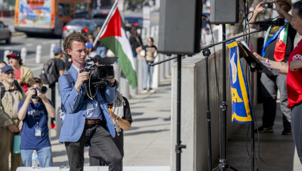 Daily Bruin videographer captures a news conference.