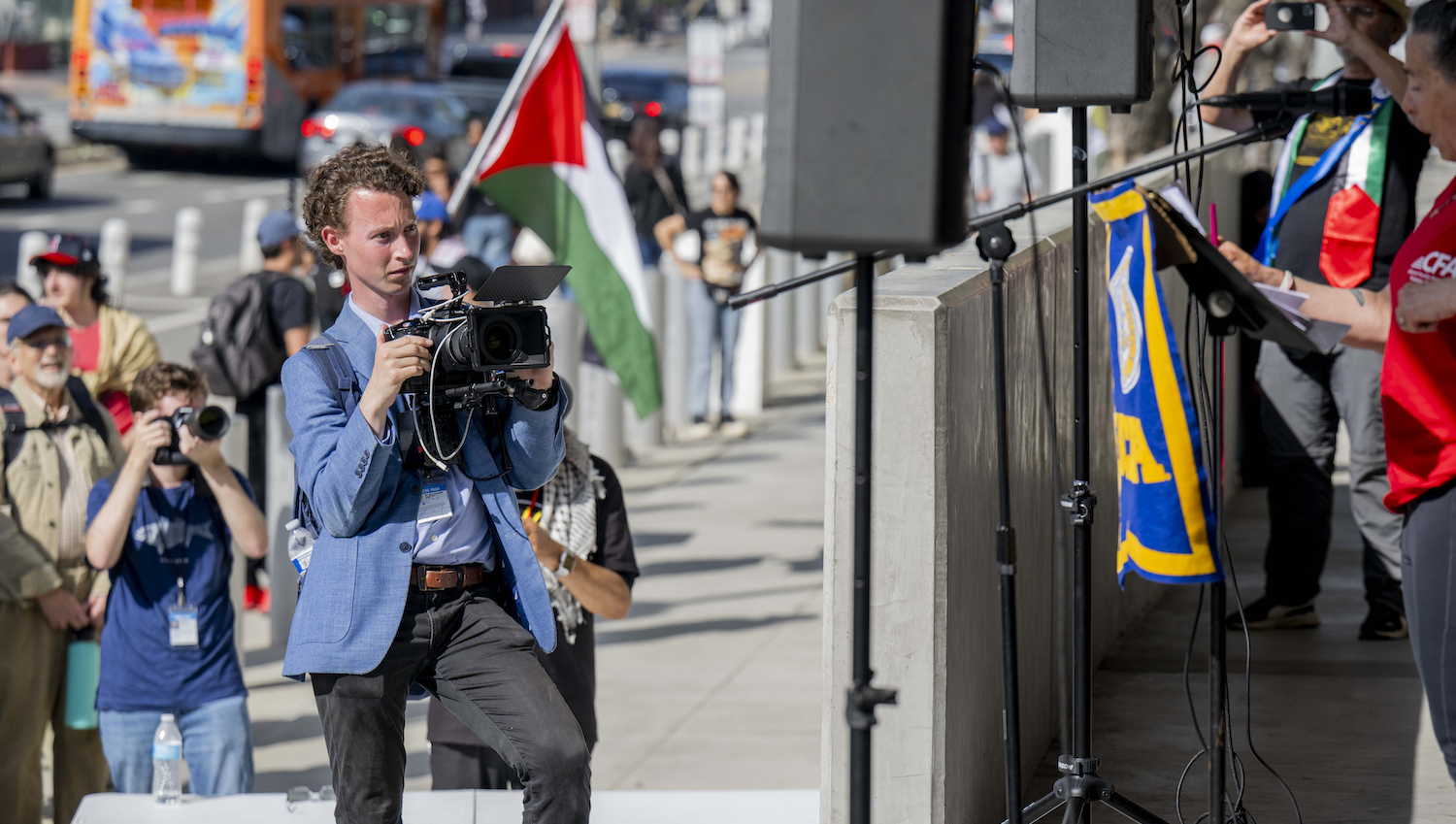 Daily Bruin videographer at a news conference