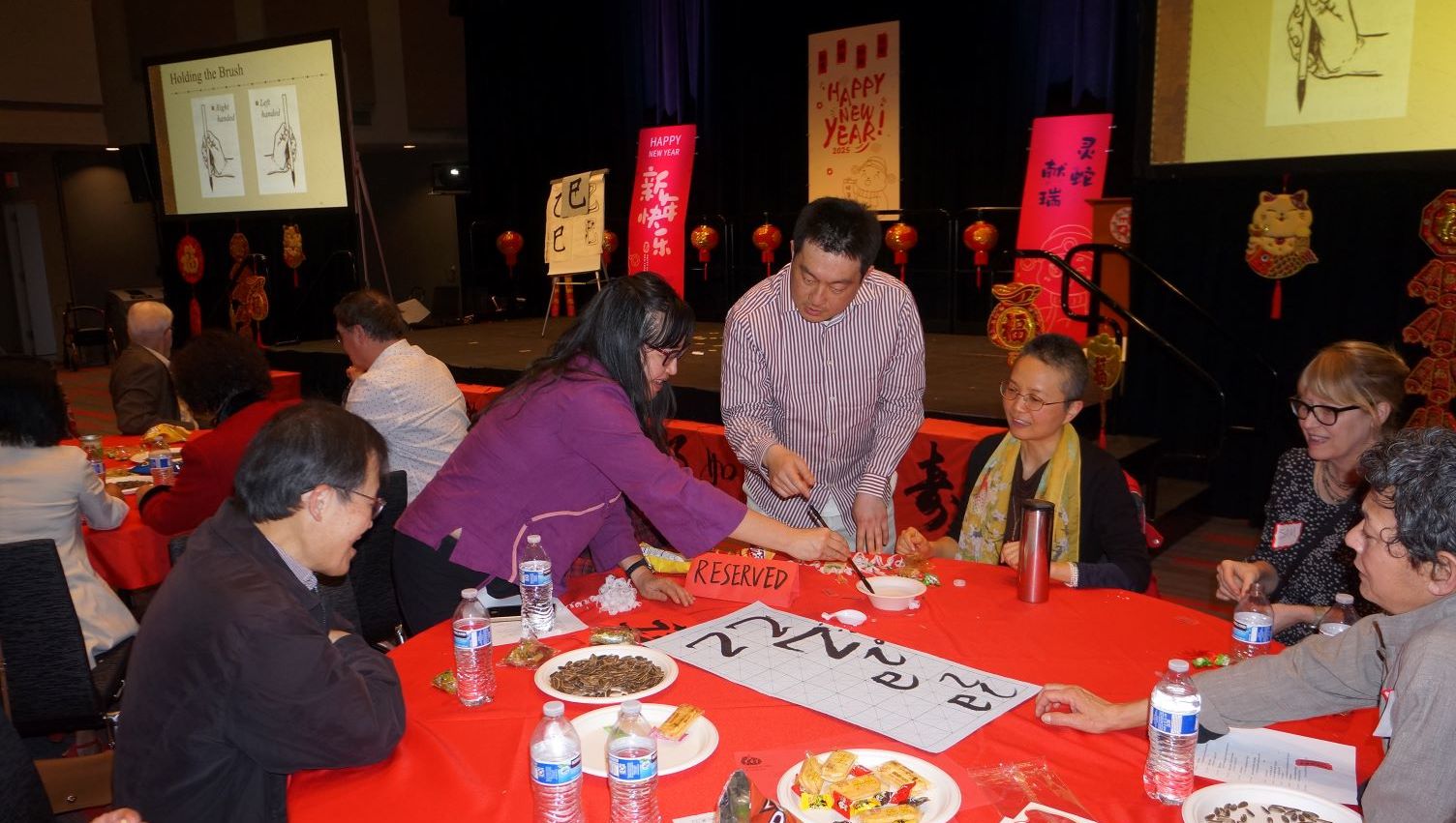 Attendees gathered around a table at the 2025 Chinese New Year Celebration