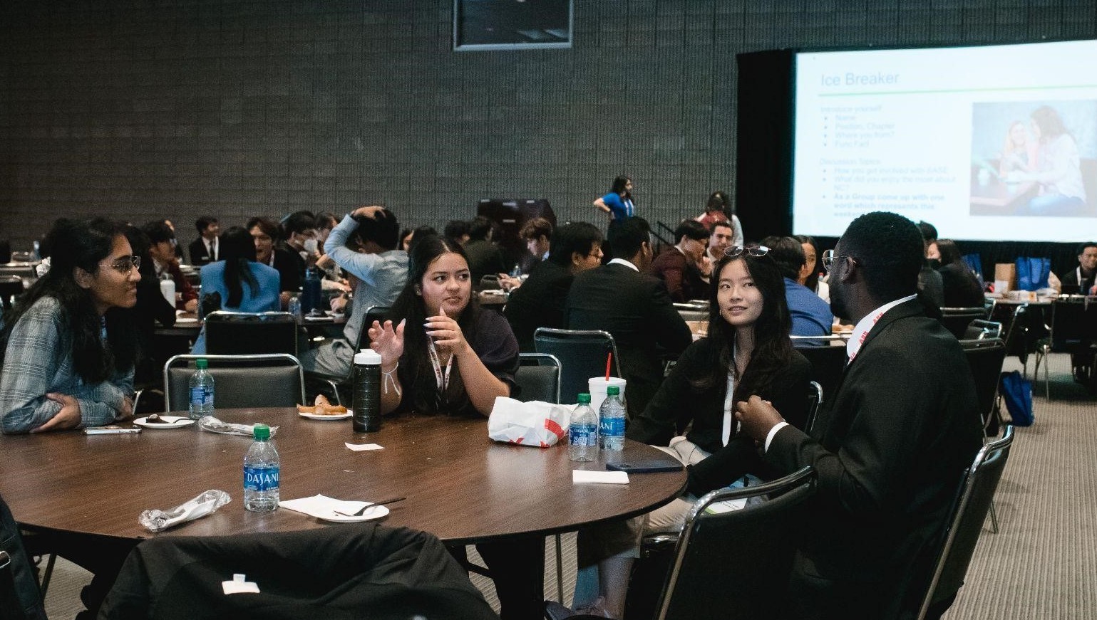 Students speaking with each other during the conference.