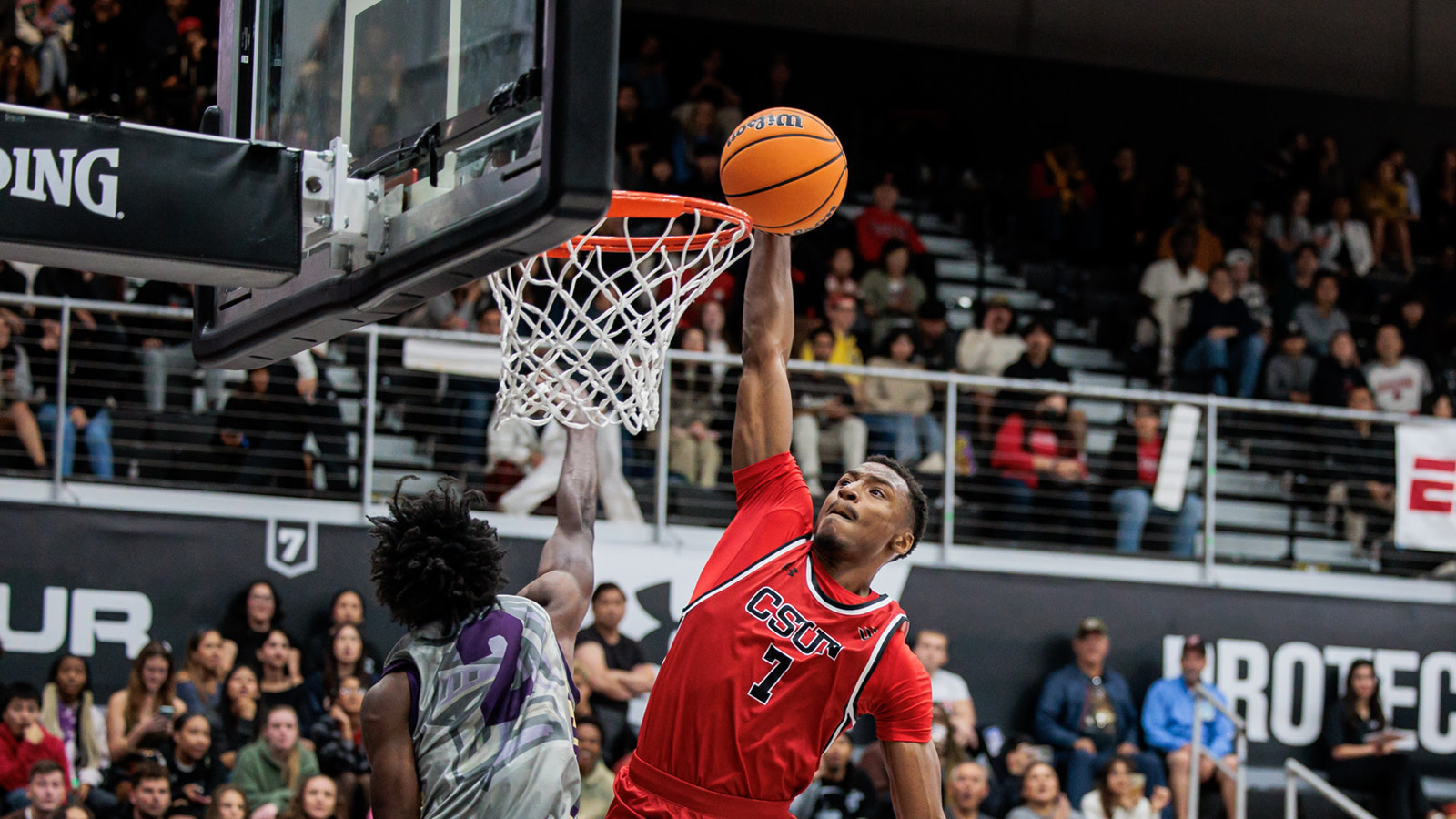 CSUN Basketball team huddling around coach