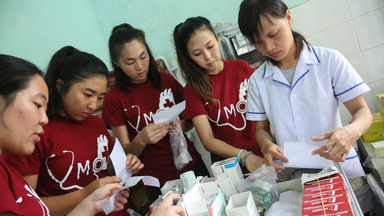 Volunteers helping sort medications at the pharmacy portion of our mobile clinics