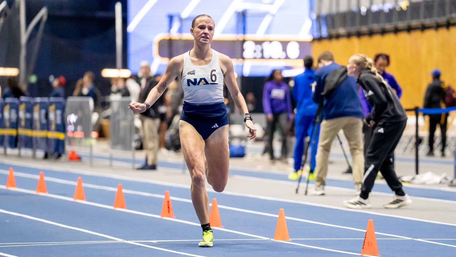 Woman running on track at NAU